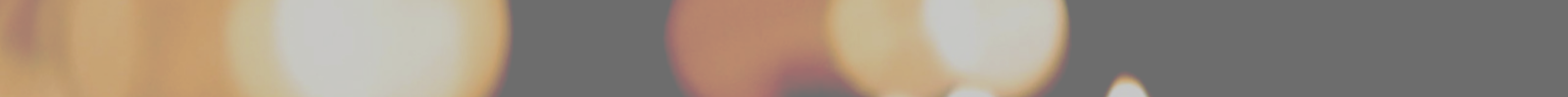 Blurry Banner showing Candles Glowing in the distance
